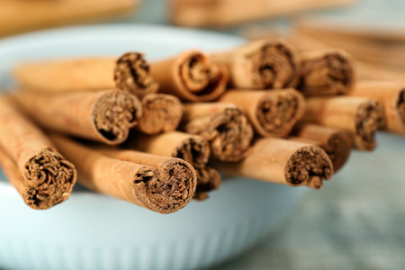Aromatic cinnamon sticks in bowl, closeup viewの写真素材