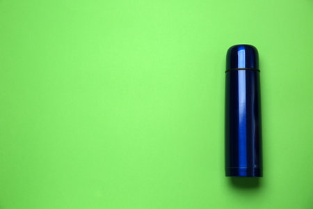 New modern flask on green background, top view. Space for textの写真素材