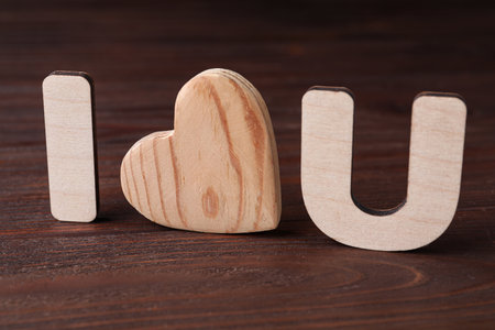Phrase I Love You made of wooden letters and heart on tableの写真素材