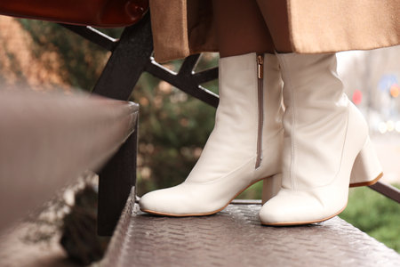 Woman wearing stylish leather shoes on stairs outdoors, closeupの写真素材