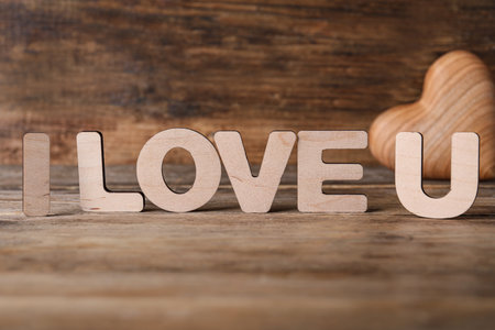 Phrase I Love U and heart on wooden tableの写真素材