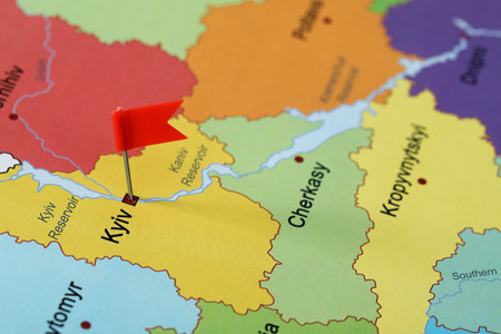 Map of Ukraine with red flag push pin placed on Kyiv, closeupの写真素材