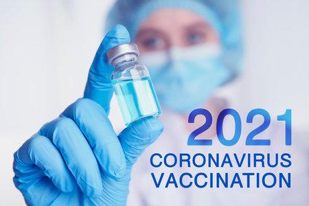 Doctor holding vial with coronavirus vaccine, closeupの写真素材