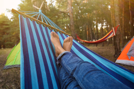Woman resting in comfortable hammock outdoors, closeupの写真素材