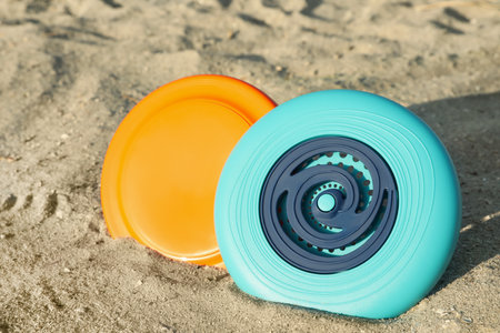 New plastic flying discs on sandy beach, closeupの写真素材