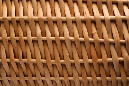 Handmade wicker basket made of natural material as background, closeup viewの写真素材