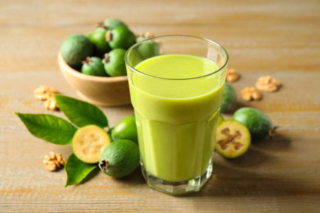 Fresh feijoa smoothie and fresh fruits on wooden table, closeupの写真素材