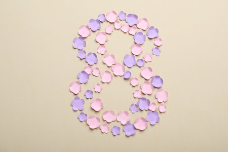 Number 8 made with paper flowers on beige background, flat lay. International Women's dayの写真素材