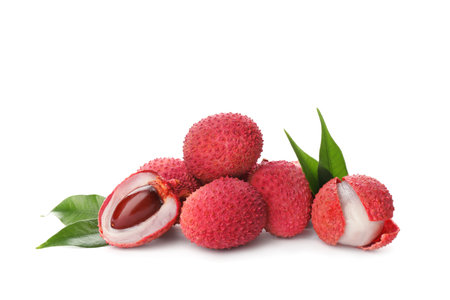 Pile of fresh ripe lychees with green leaves on white backgroundの写真素材