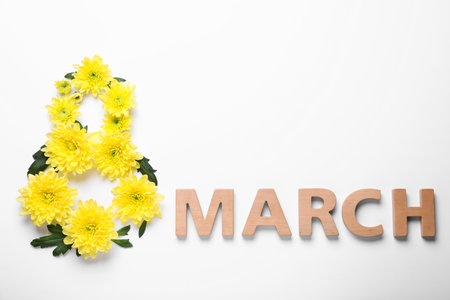 8 March greeting card design with chrysanthemum flowers and wooden letters on white background, top view. International Women's dayの写真素材