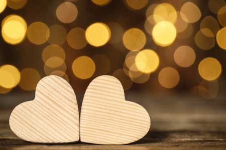 Wooden decorative hearts on table against blurred background, space for text. Valentine's Dayの写真素材