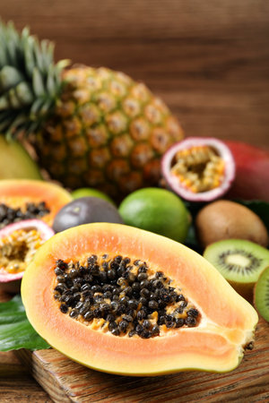 Fresh ripe papaya and other fruits on wooden tableの写真素材