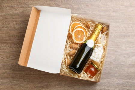 Stylish gift set in box on wooden table, top viewの写真素材