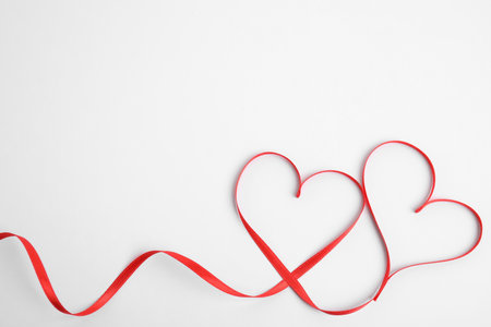 Hearts made of red ribbon on white background, top view. Valentine's day celebrationの写真素材
