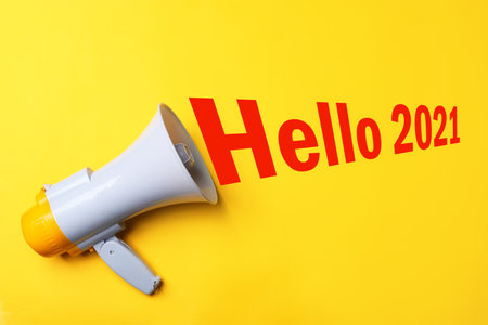 Hello 2021. Megaphone on yellow background, top viewの写真素材