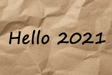 Text Hello 2021 on crumpled paper, top viewの写真素材