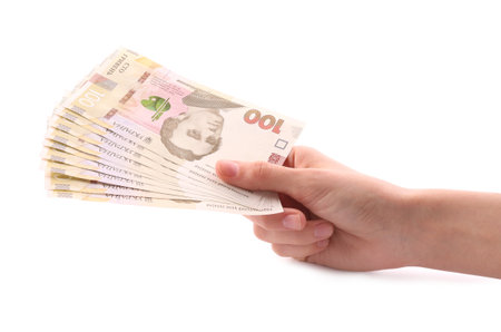 Woman holding Ukrainian money on white background, closeupの写真素材