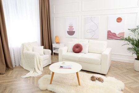 Stylish living room interior with comfortable sofa and picturesの写真素材