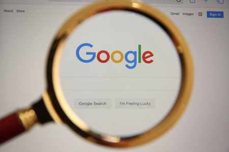 MYKOLAIV, UKRAINE - OCTOBER 30, 2020: Looking through magnifying glass at screen with Google search...