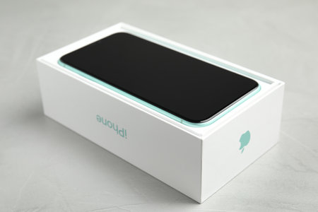 MYKOLAIV, UKRAINE - JULY 10, 2020: New modern Iphone 11 in original box on light grey table