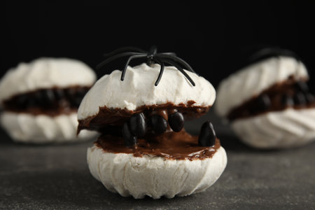 Delicious desserts decorated as monsters on gray table. Halloween treatmentの写真素材