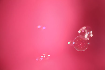 Beautiful translucent soap bubbles on pink background, space for textの写真素材