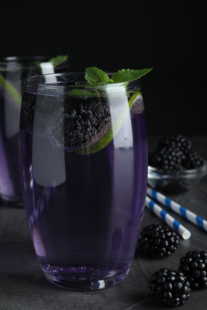 Delicious blackberry lemonade made with soda water on gray tableの写真素材