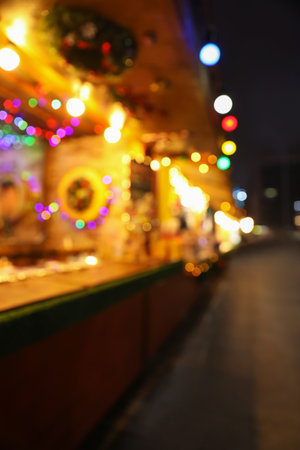 Blurred view of Christmas fair stalls outdoors at nightのeditorial素材