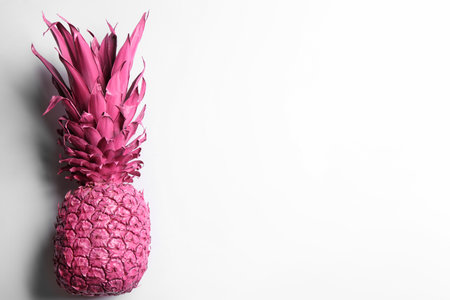 Painted pink pineapple on white background, top view. creative conceptの写真素材