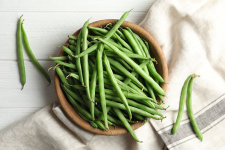Fresh green beans on white wooden table, flat layの写真素材