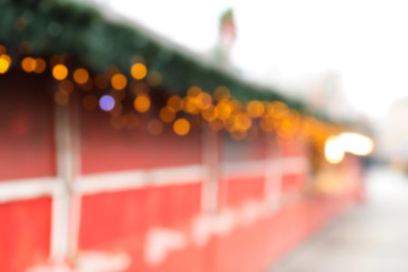 Blurred view of Christmas fair stalls outdoorsの写真素材