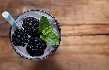 Delicious blackberry lemonade made with soda water on table, top view. Space for textの写真素材