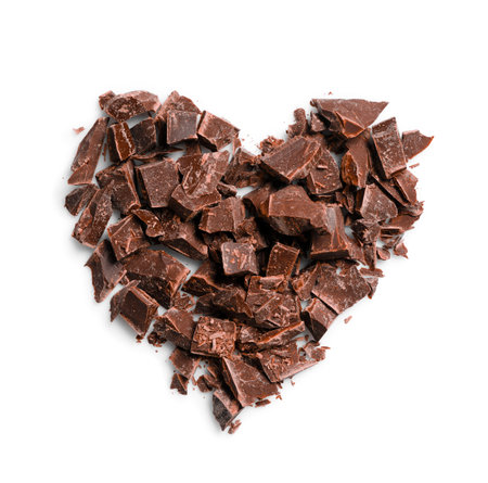 Heart made with dark chocolate crumbles on white background, top viewの写真素材