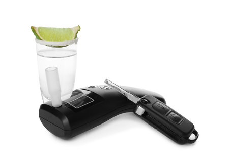 Modern breathalyser, alcohol and car key on white backgroundの写真素材