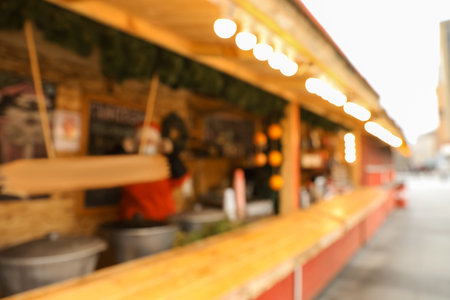 Blurred view of Christmas fair stall outdoorsの写真素材