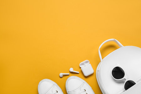 Flat lay composition with stylish backpack on yellow background, space for textの写真素材
