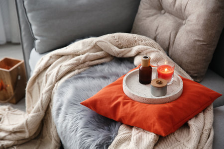 Aroma candles and oil on sofa in living room. interior designの写真素材