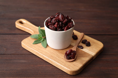 Composition with tasty dried cranberries on wooden tableの写真素材