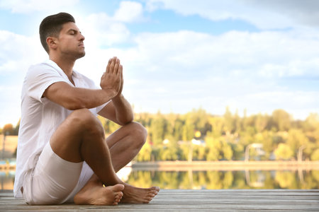 Man near river at sunset, space for text. nature healing powerの写真素材