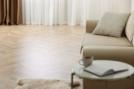 Parquet floor in room with sofa and coffee tableの写真素材