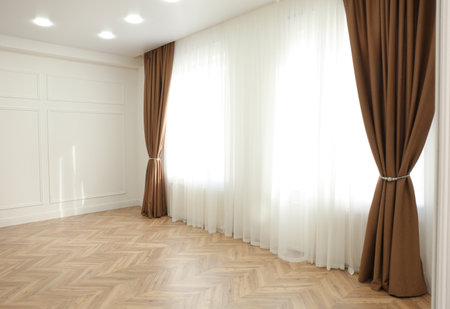 Windows with elegant curtains in modern roomの写真素材