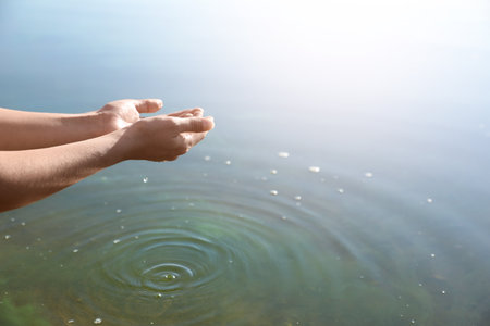 Woman taking pure water from river, closeup. nature healing powerの写真素材