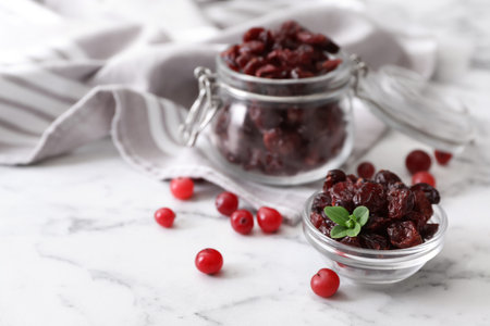 Composition with tasty fresh and dried cranberries on white marble tableの写真素材