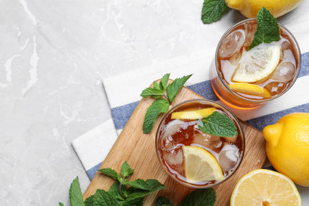 Delicious iced tea on light gray marble table, flat lay. Space for textの写真素材