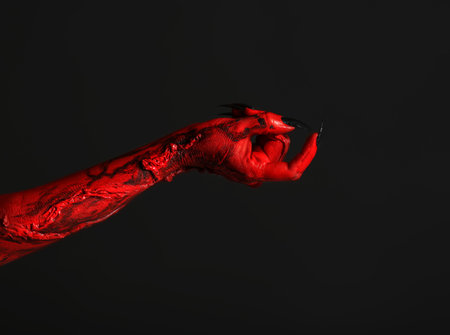 Scary monster on black background, closeup of hand. halloween characterの写真素材