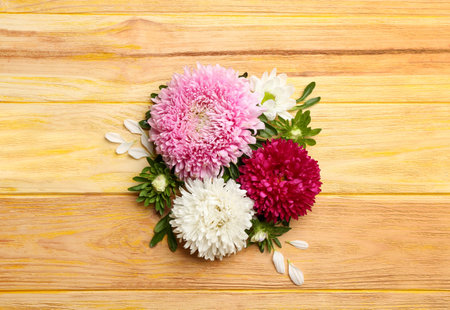 Beautiful asters on wooden background, flat lay. autumn flowersの写真素材