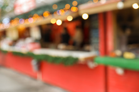 Blurred view of Christmas fair stall outdoorsの写真素材