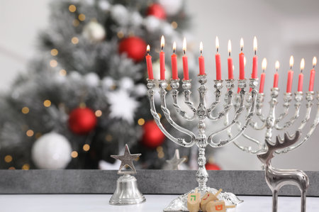 Silver menorah, Christmas decorations and dreidels with symbols He, Pe, Nun, Gimel near mirror on table, space for text. Hanukkah symbolsの写真素材