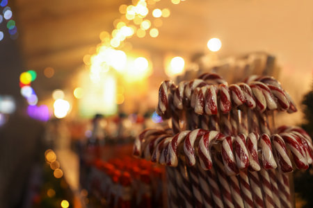 Candy canes on Christmas fair stall display, closeup. Space for textの写真素材