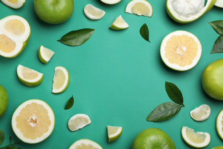 Frame of fresh ripe sweeties and green leaves on turquoise background, flat layの写真素材